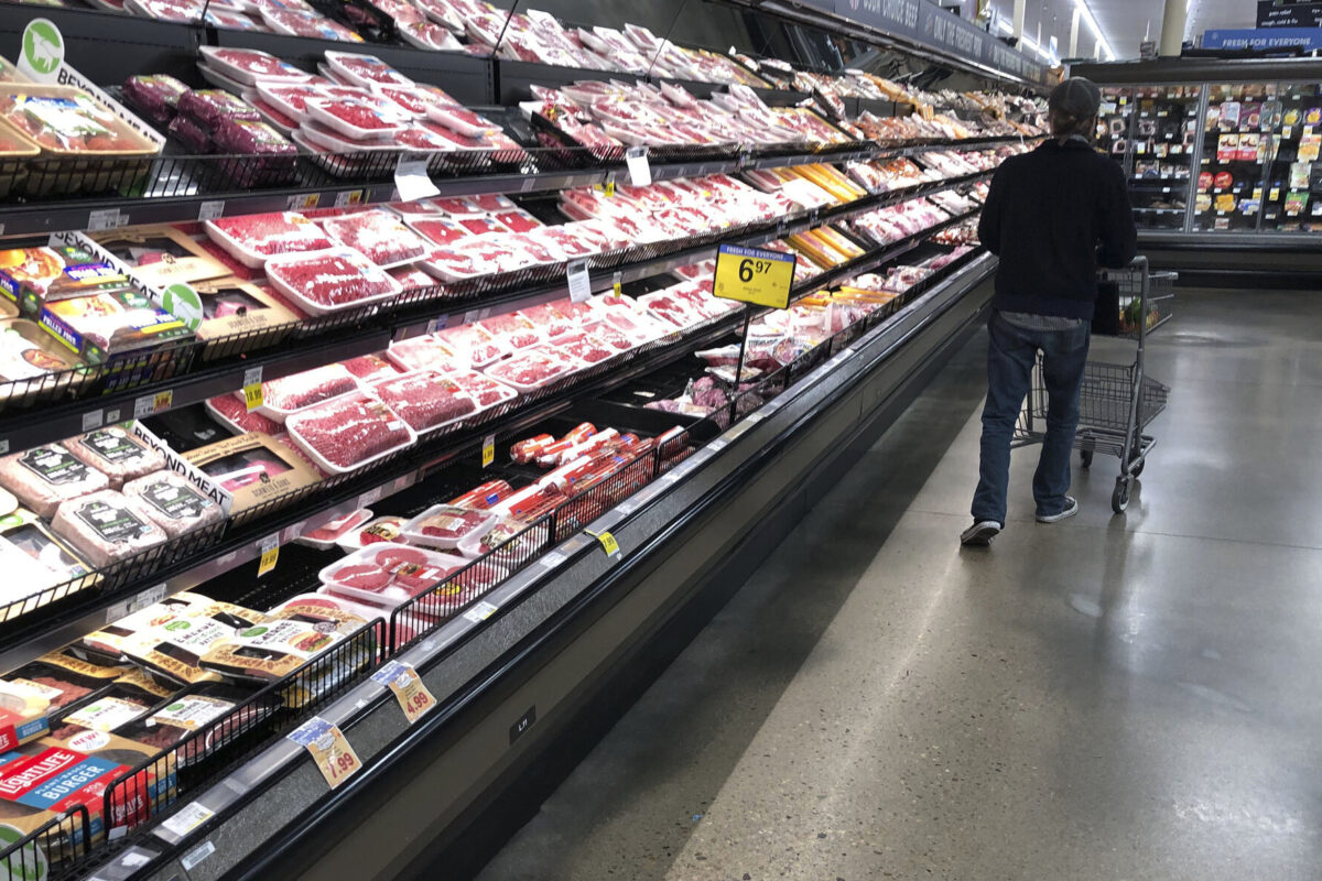 A shopper pushes his cart past a display of packaged meat in a grocery store Sunday, May 10, 2020, in southeast Denver. Problems triggered by the new coronavirus have triggered shortages of meat in some parts of the country. (AP Photo/David Zalubowski)